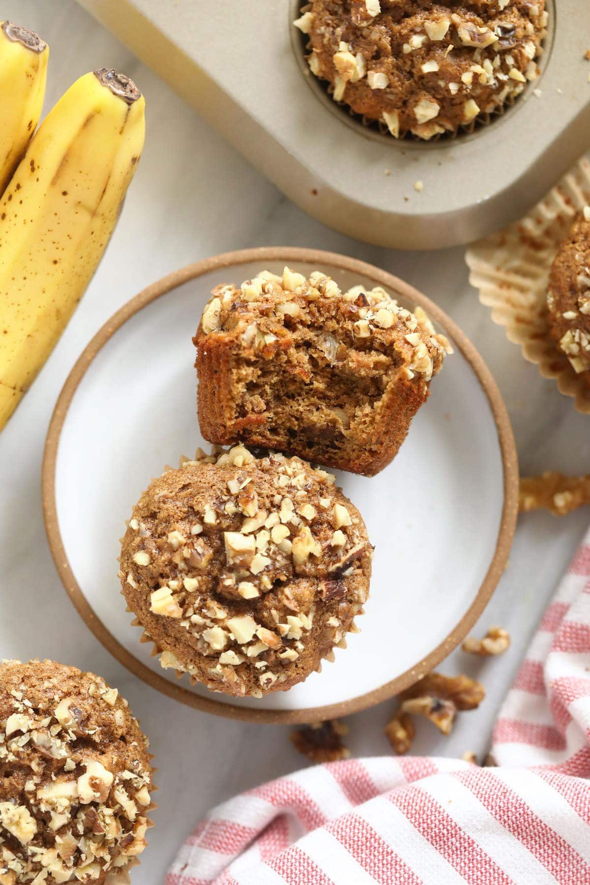 Two banana nut muffins on a plate. 