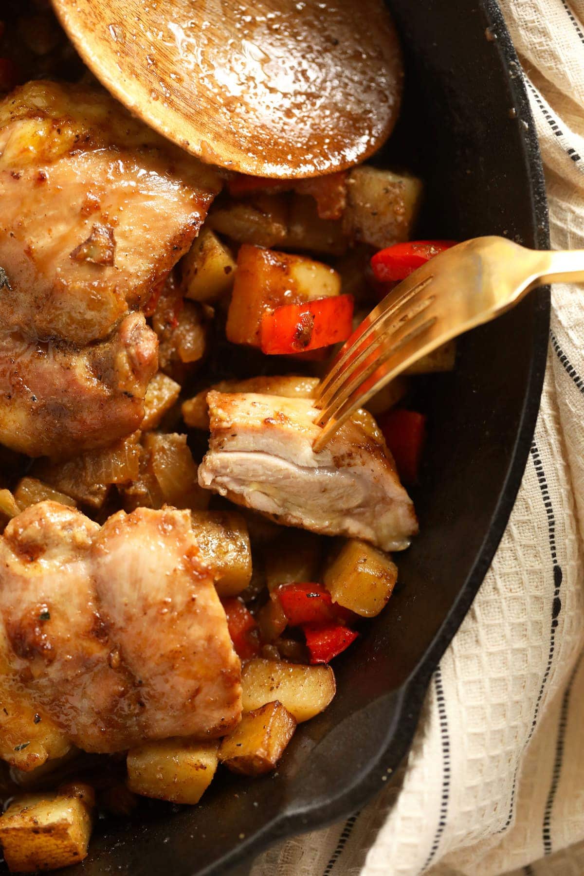 bite of a chicken thigh on a fork ready to eat