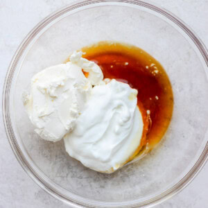 All of the ingredients for cream cheese frosting in a bowl.