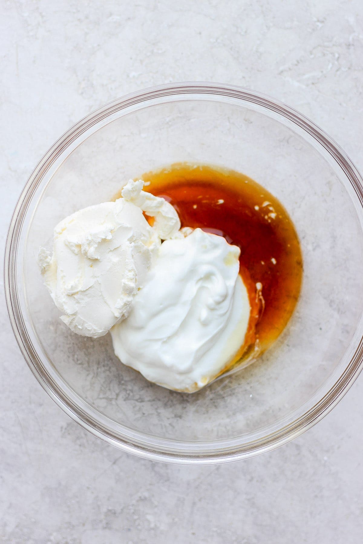 Cream cheese frosting ingredients in a bowl.