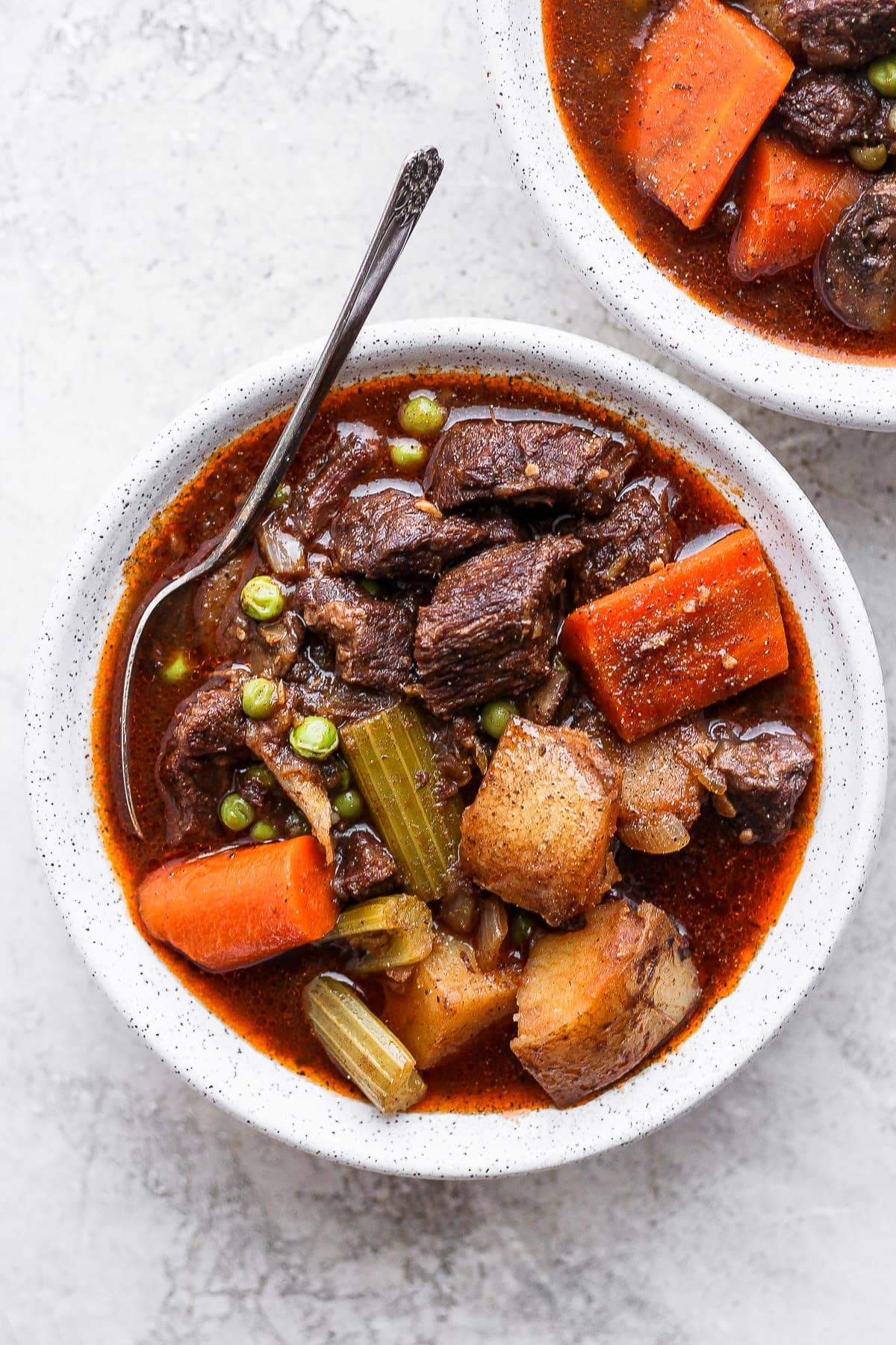 instant pot beef stew in a bowl with a spoon