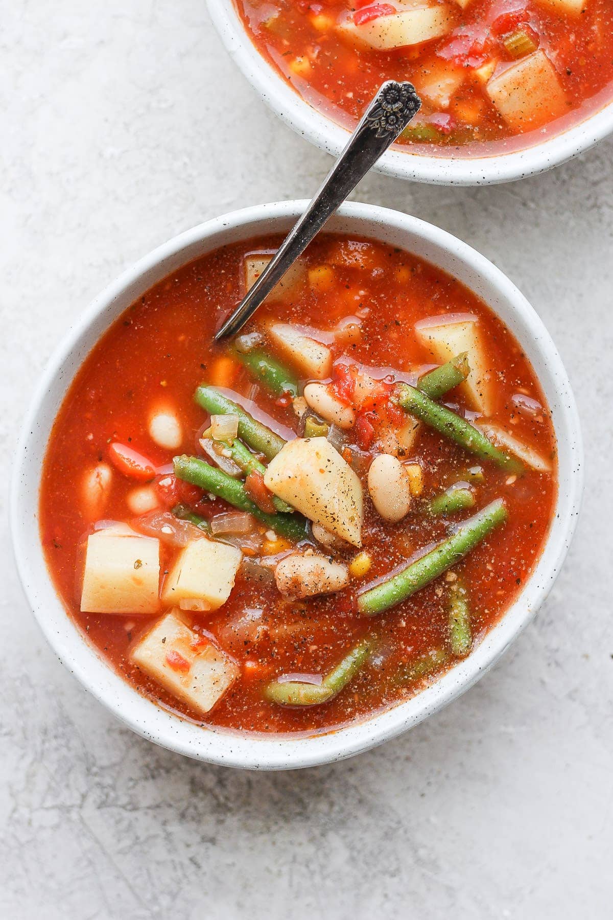 Two bowls of vegetable soup. 