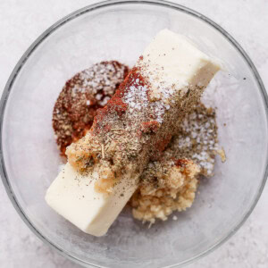 A glass bowl with a scoop of ice cream and spices resembling a whole roasted chicken.