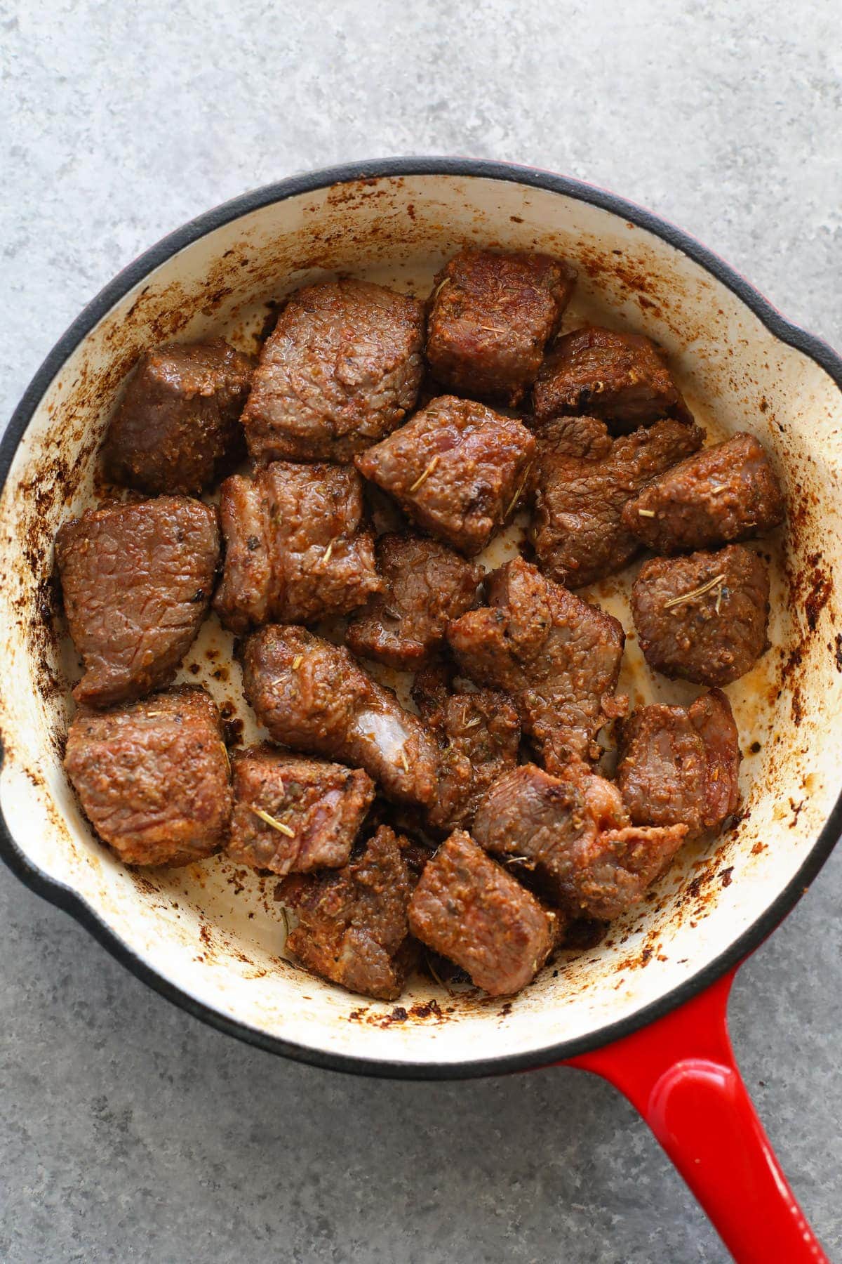 beef stew meat being browned in in a skillet