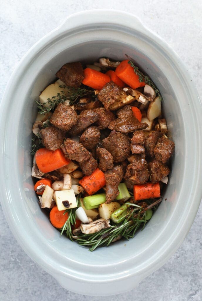 fresh ingredients for beef stew in the slow cooker