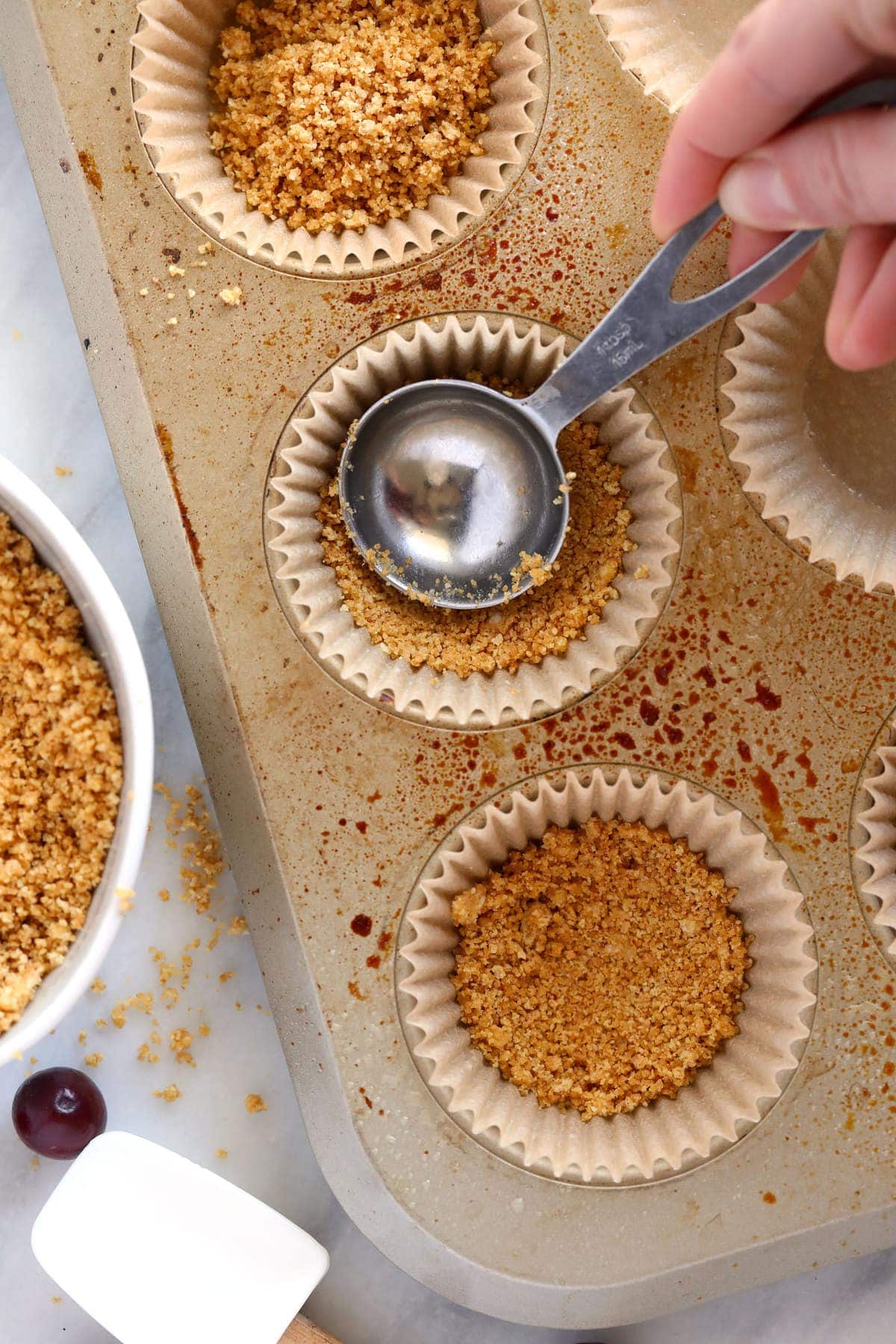 Making crust for the cheesecake bites. 