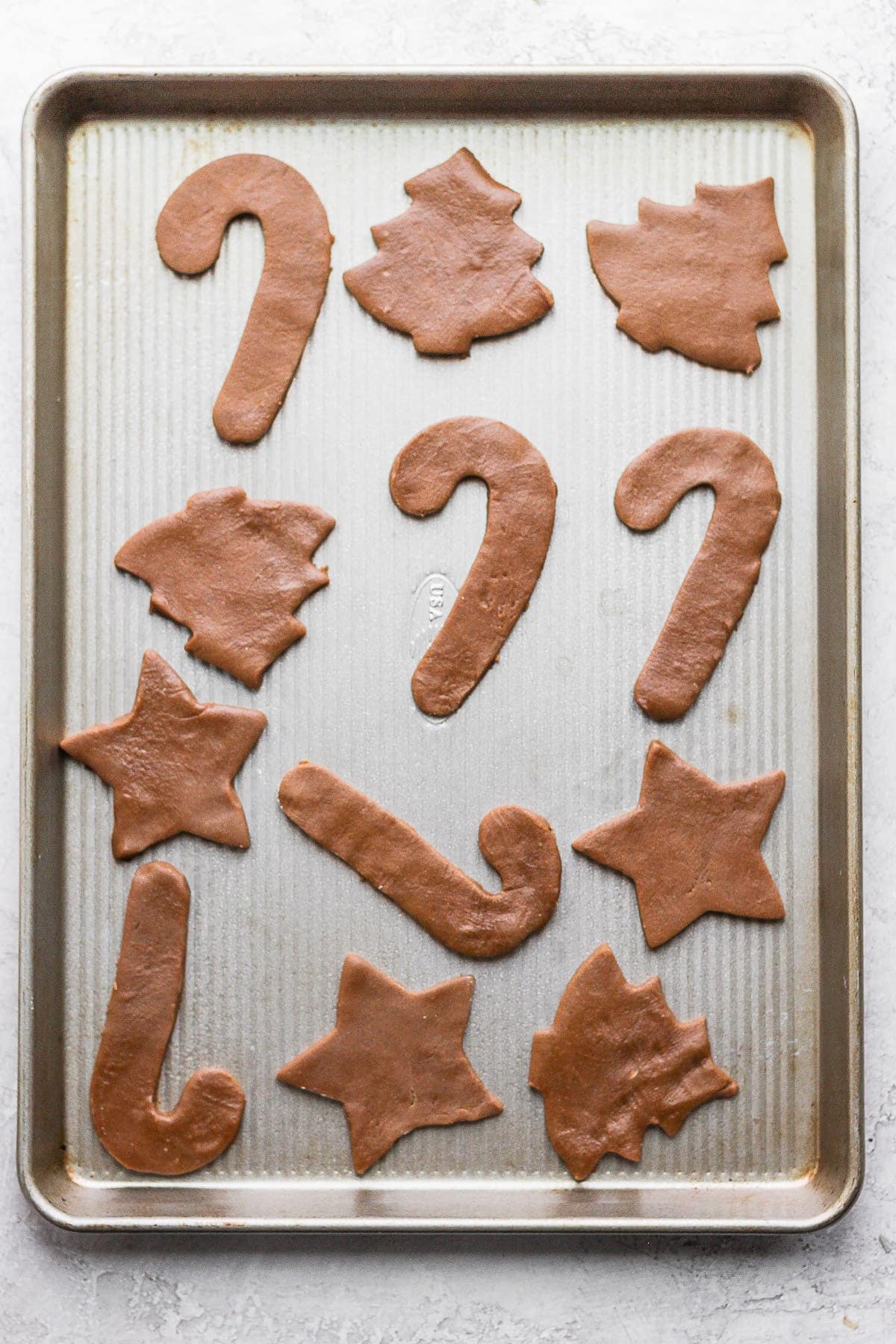 Raw gingerbread cookie dough on a baking sheet