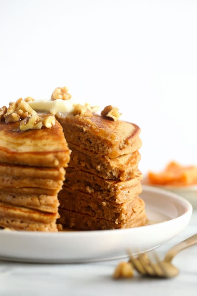 A stack of sweet potato pancakes on a plate. 