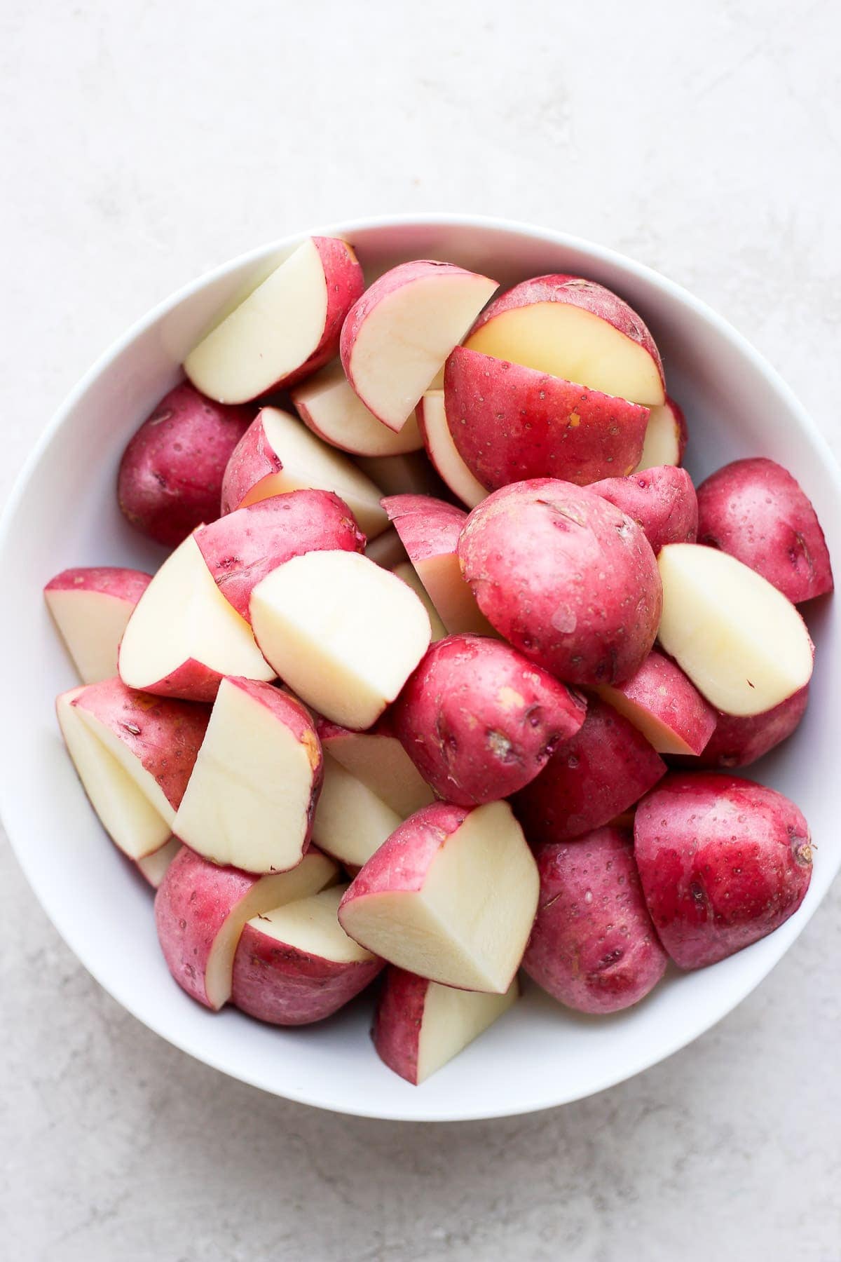 sliced red potatoes ready to be tossed in ranch and roasted