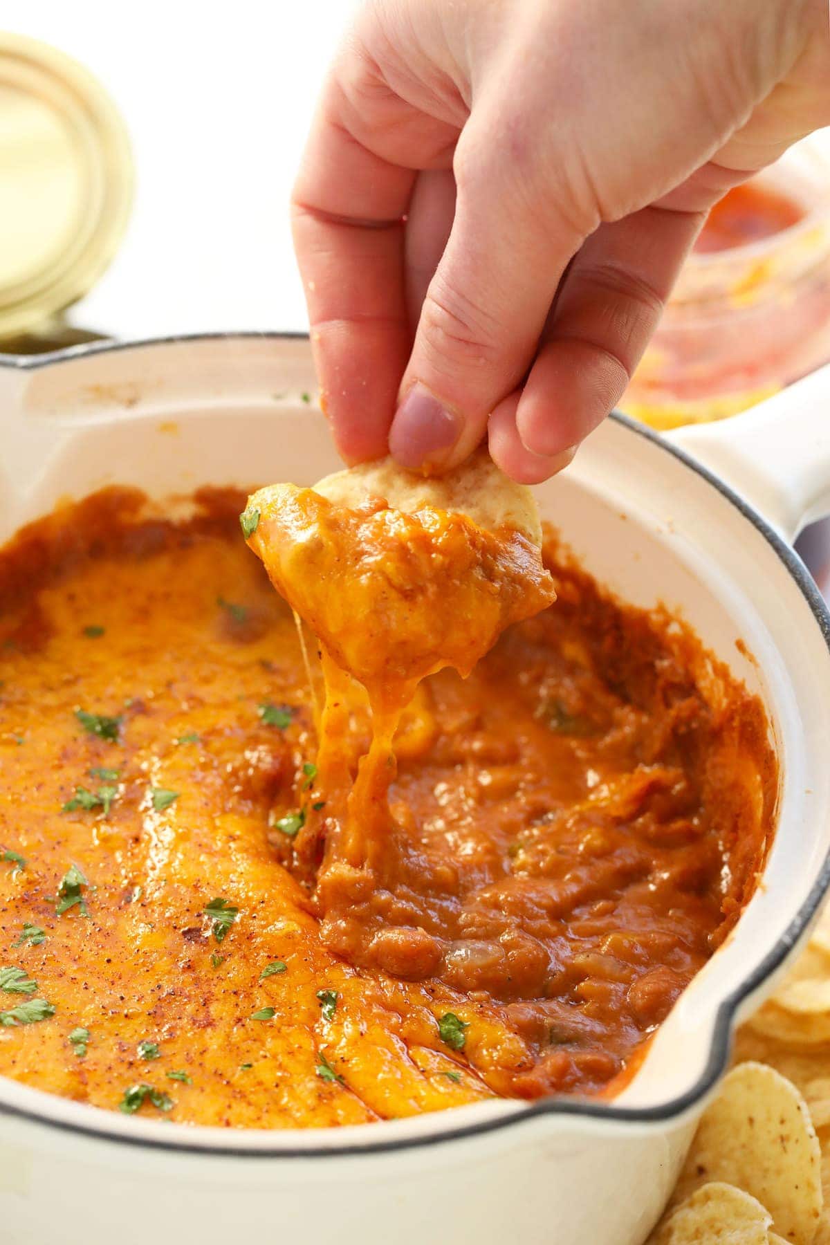 bean dip on a tortilla chip with melted cheese