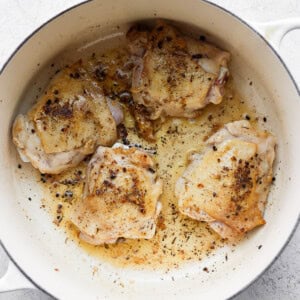 chicken breasts in a skillet on a white background.