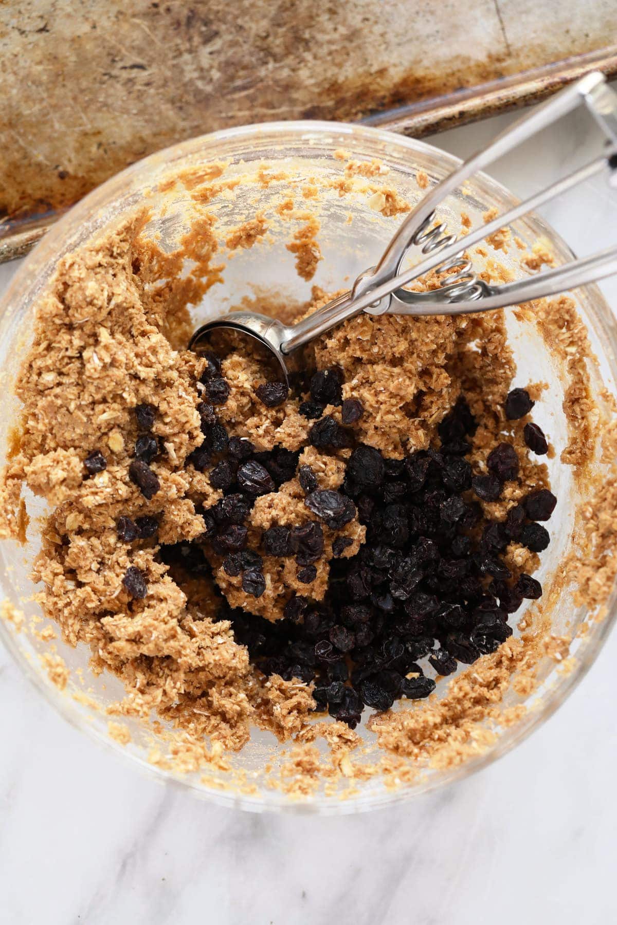 Oatmeal raisin cookie dough in a bowl.