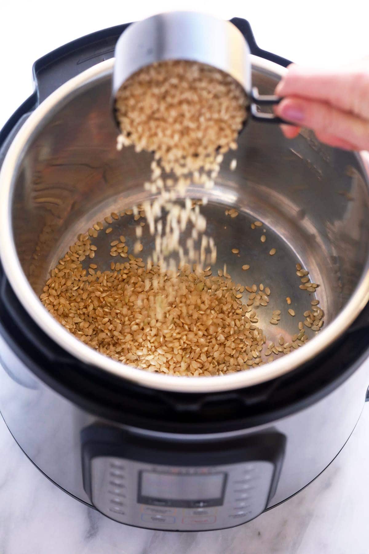 Pouring rice into the Instant Pot. 