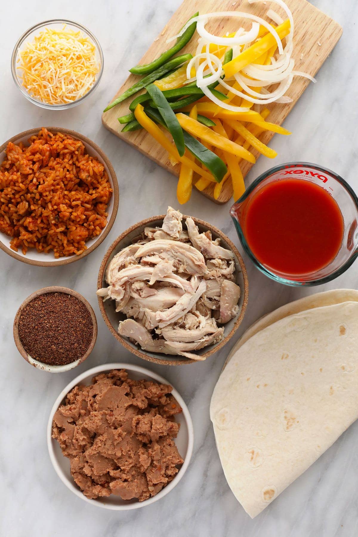 ingredients for shredded chicken burritos, ready to be assembled.