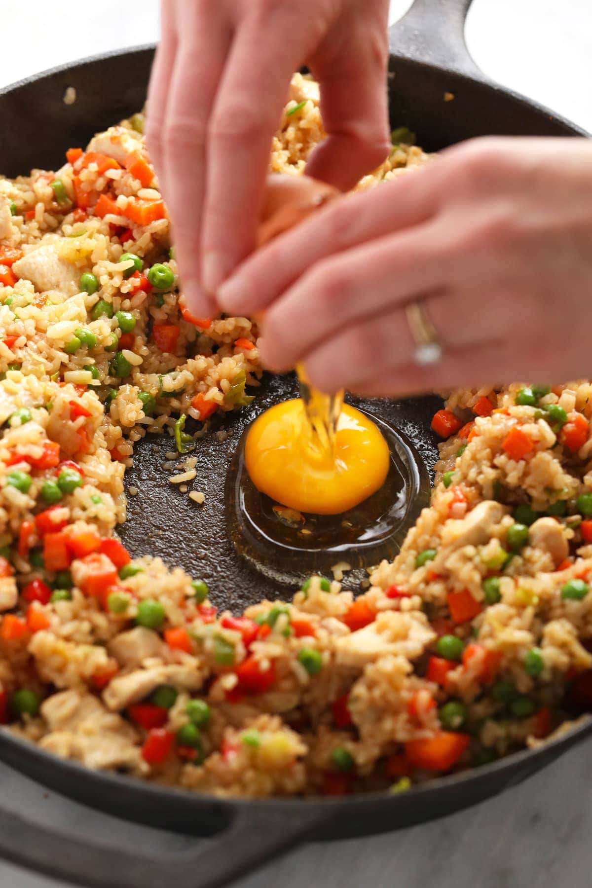 cracking eggs into the middle of frying pan