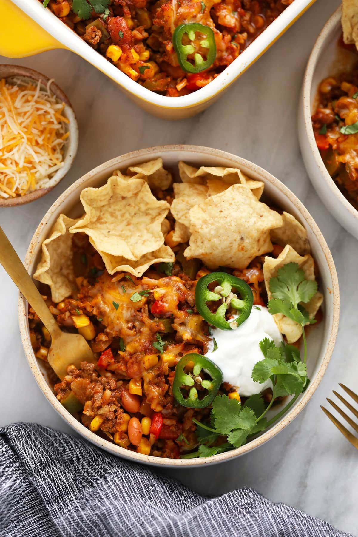 Mexican casserole in a bowl with tortilla chips. 