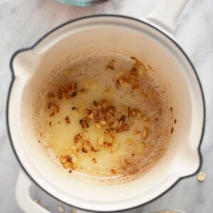 Oatmeal in a pot with cinnamon and oats.