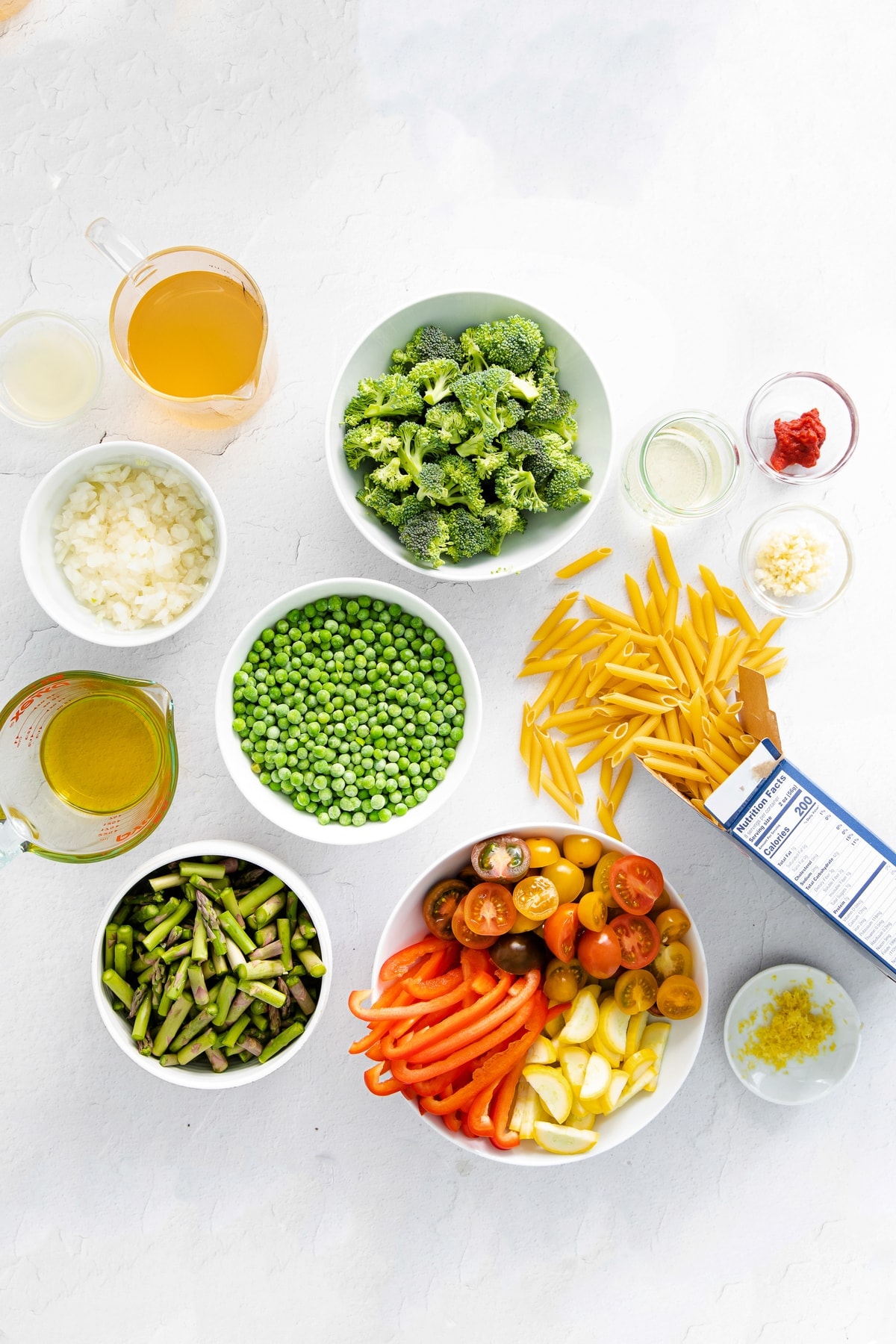 pasta primavera ingredients in bowls, ready to be prepared