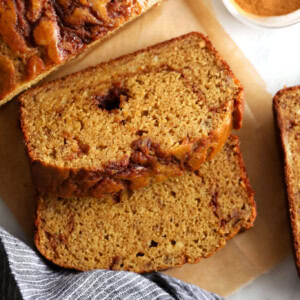 Cinnamon swirl banana bread on a cutting board.