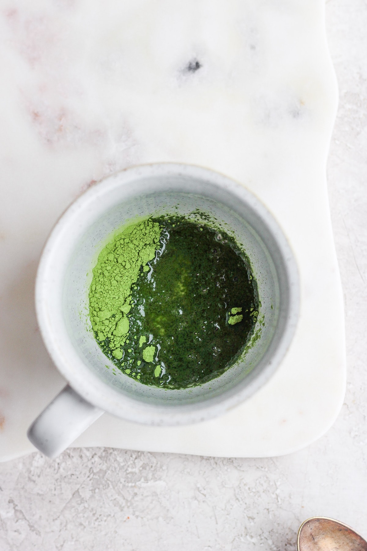 hot water and matcha powder in mug