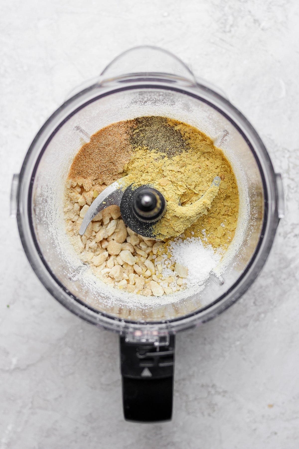 vegan parmesan cheese in a food processor about to be blended