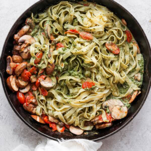 a skillet filled with pasta and vegetables.