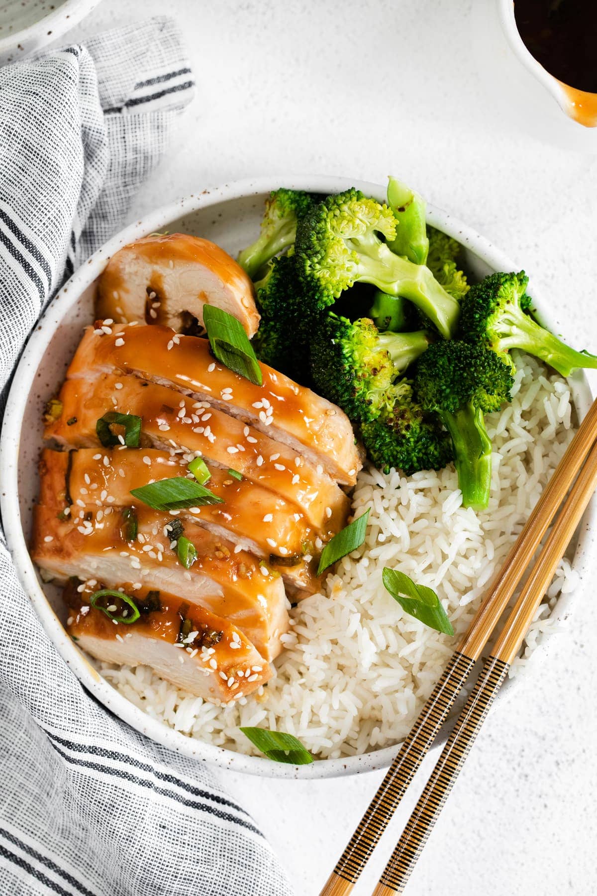 sliced teriyaki chicken next to broccoli and white rice