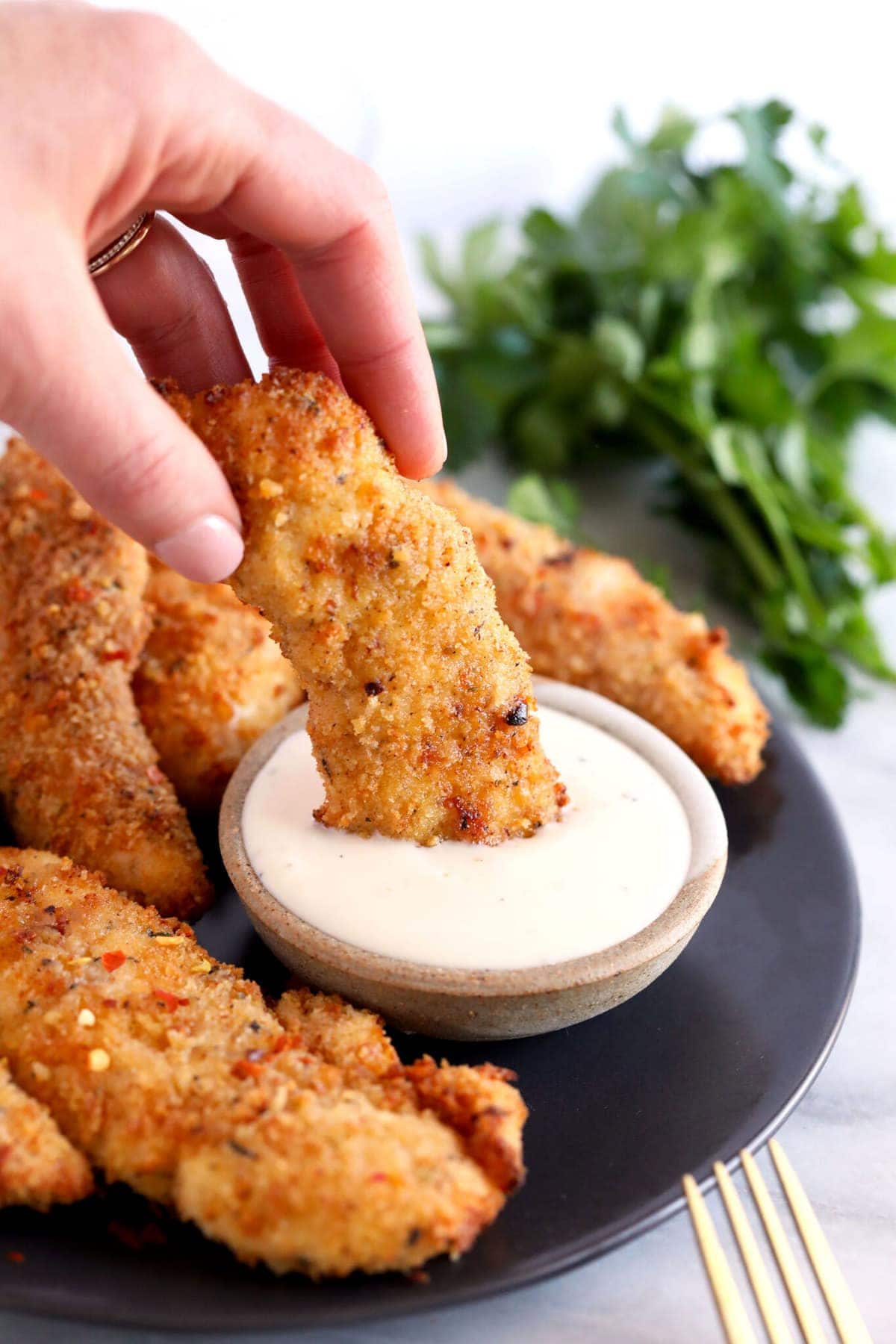 dipping chicken tender in ranch