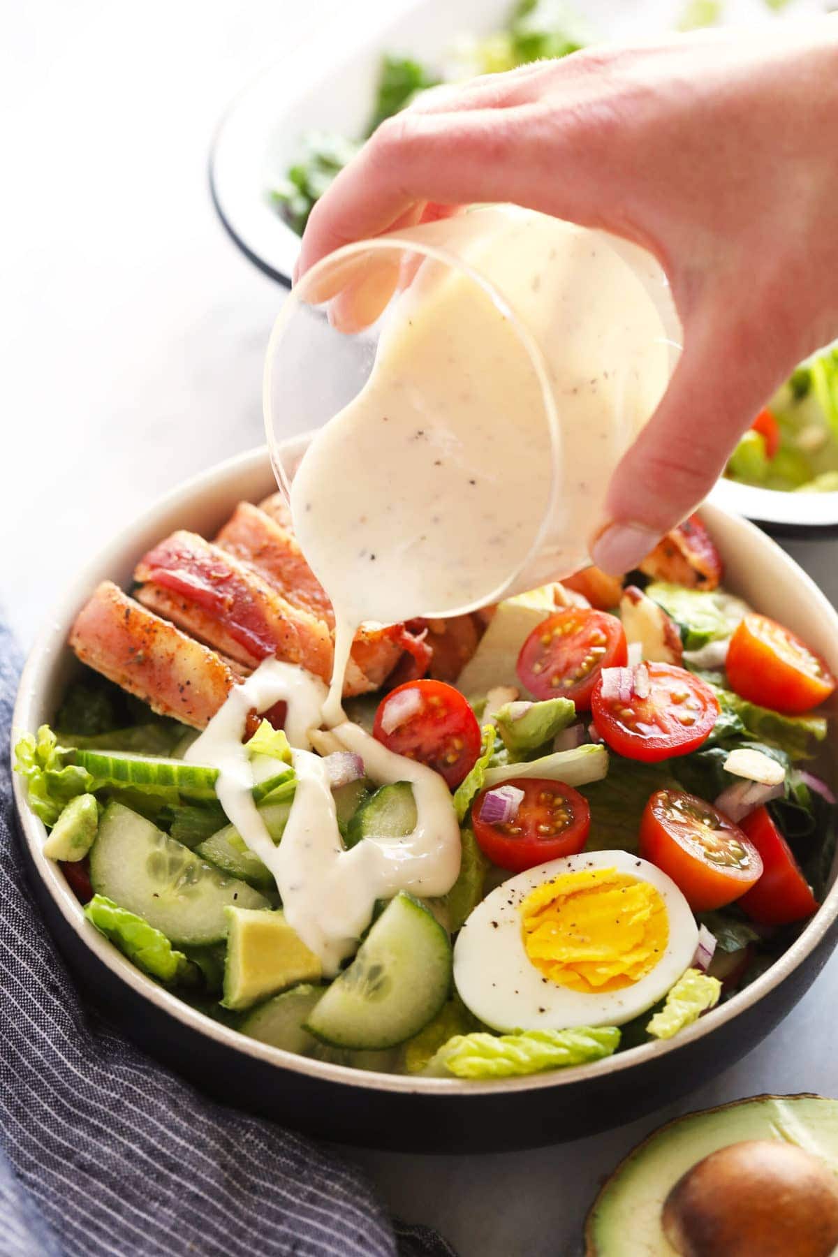 pouring dressing onto salad