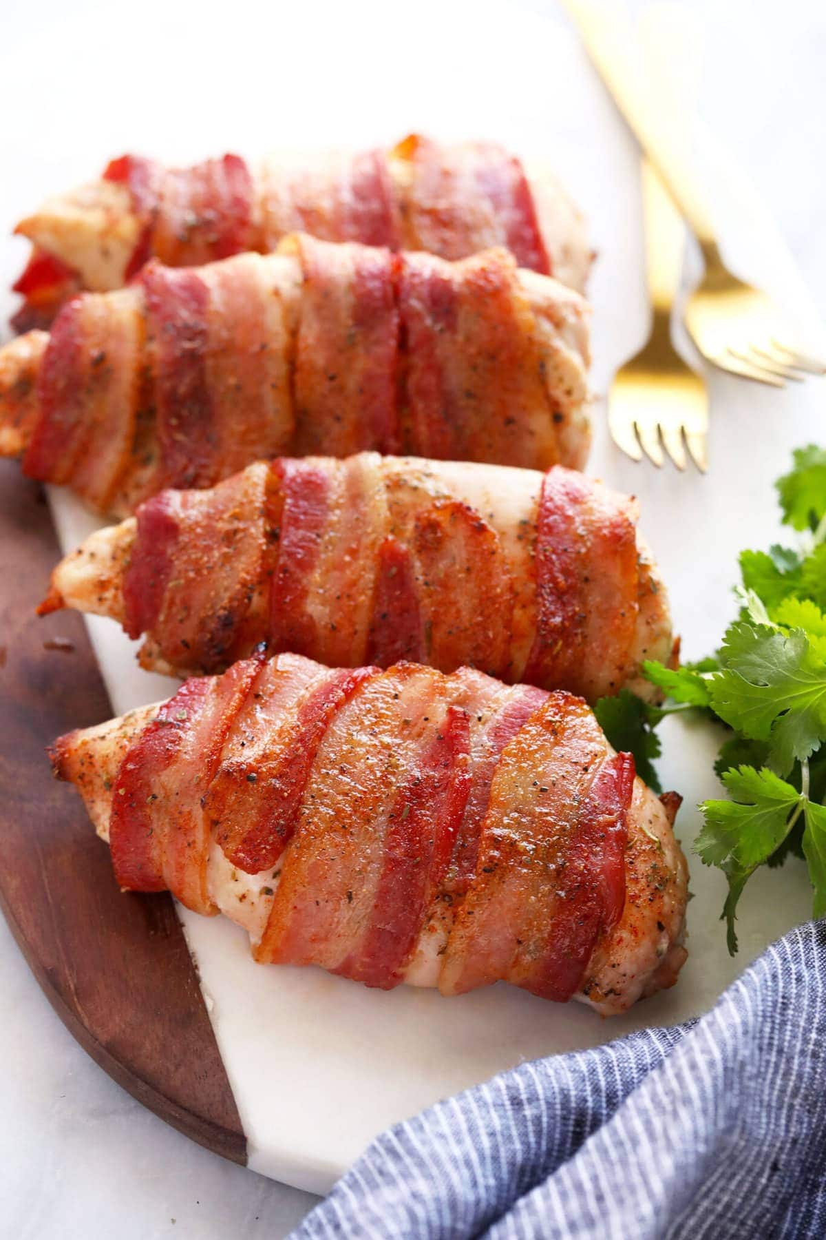 bacon wrapped chicken on cutting board