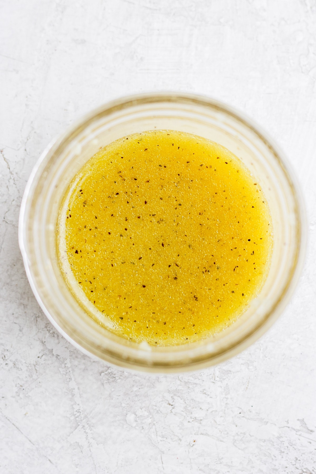 Lemon vinaigrette in a small jar. 