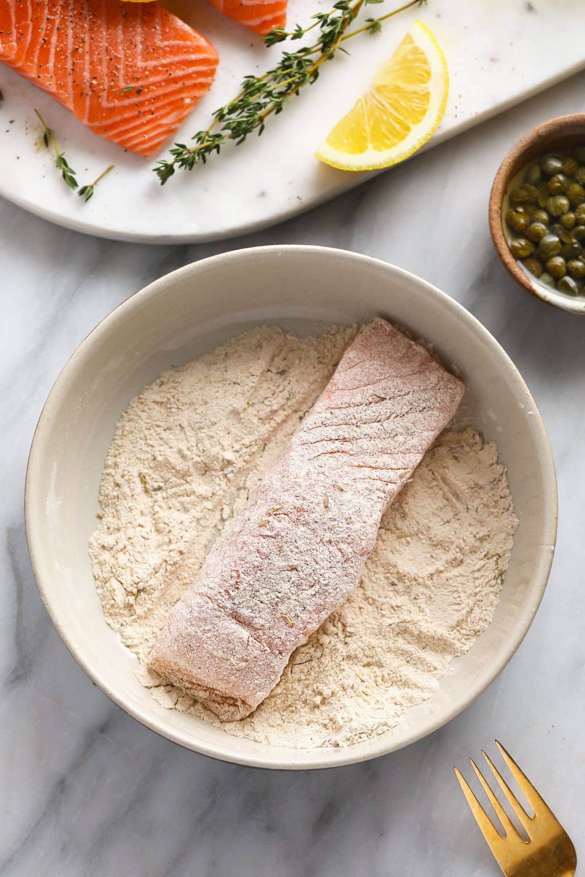 Dredging salmon through flour. 