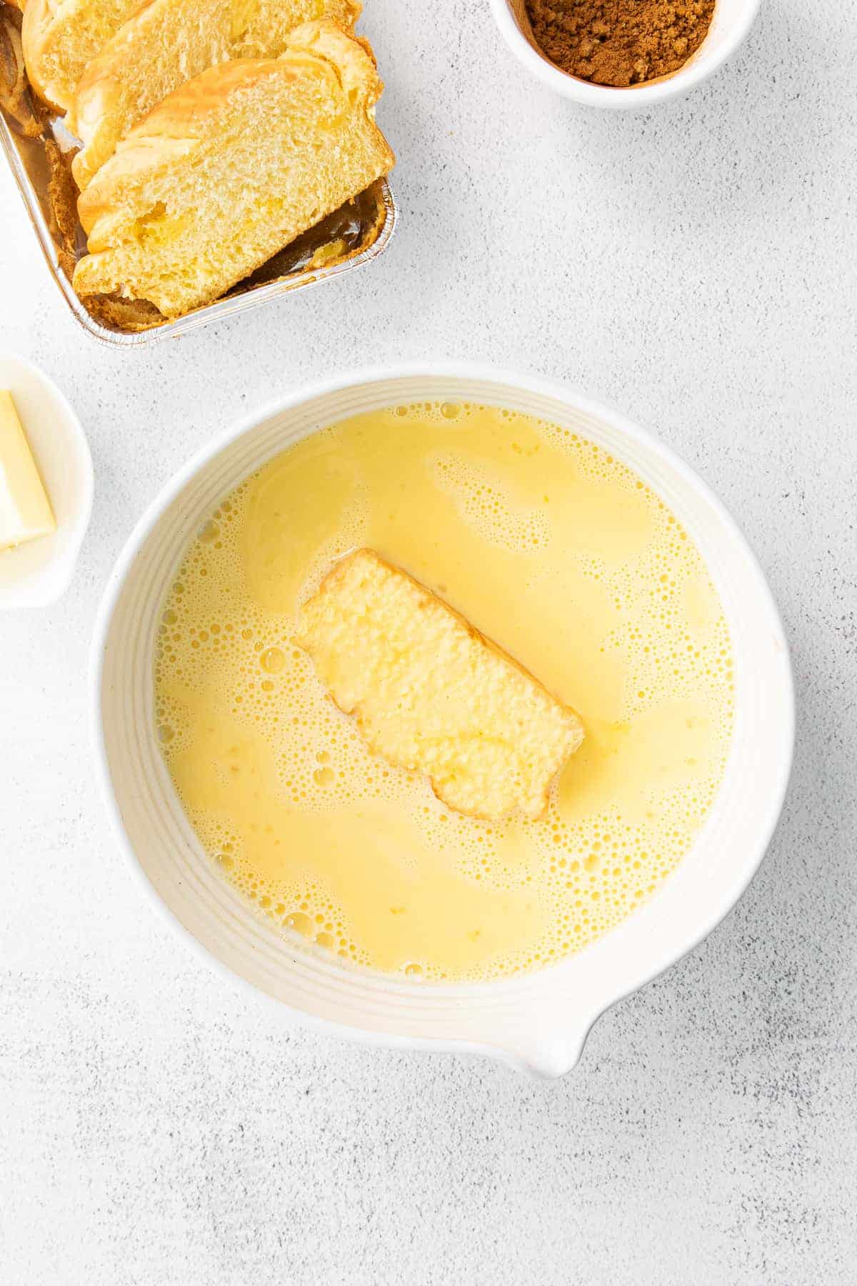 slice of bread in an egg wash for french toast