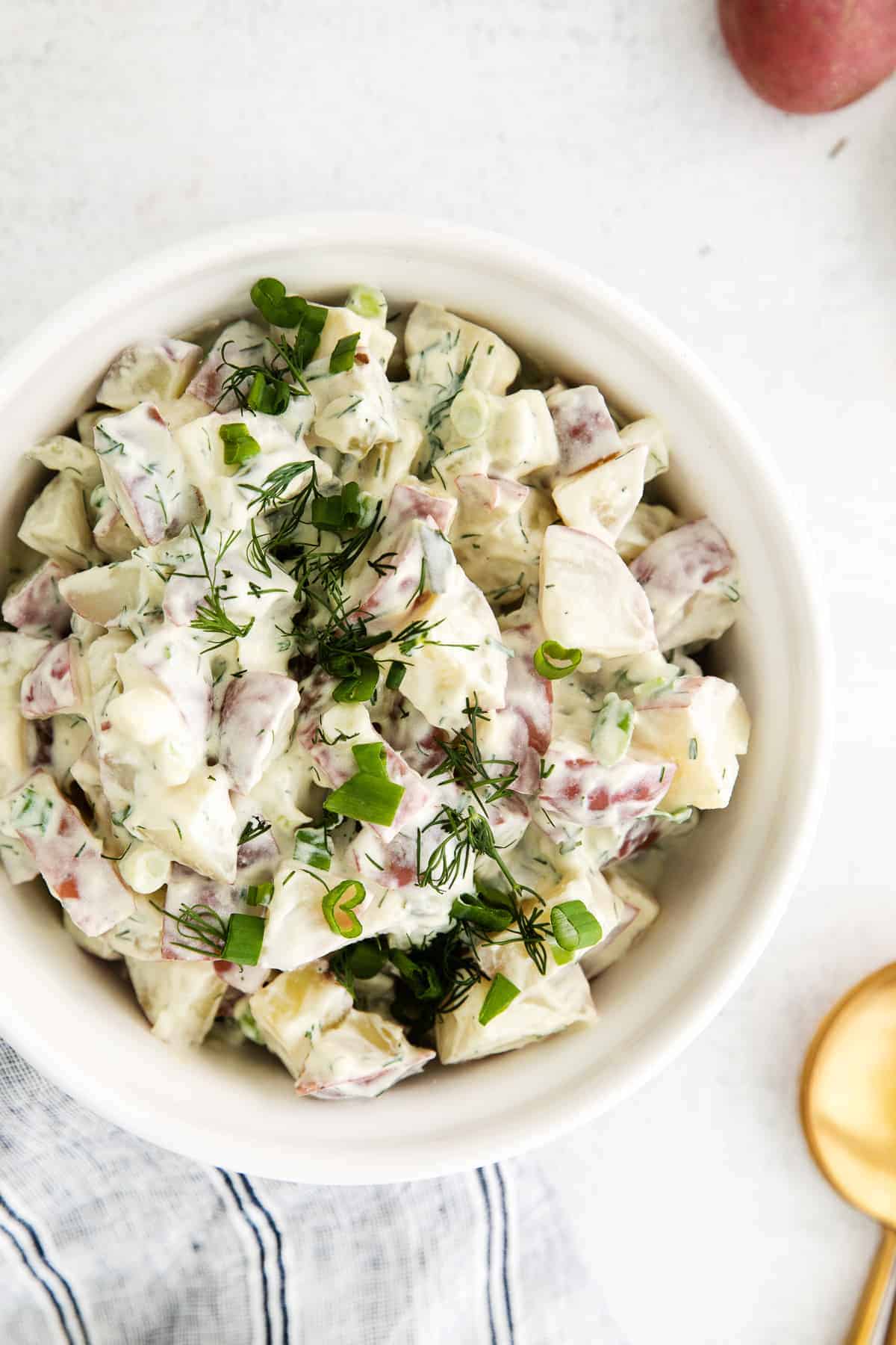 A bowl of red potato salad. 