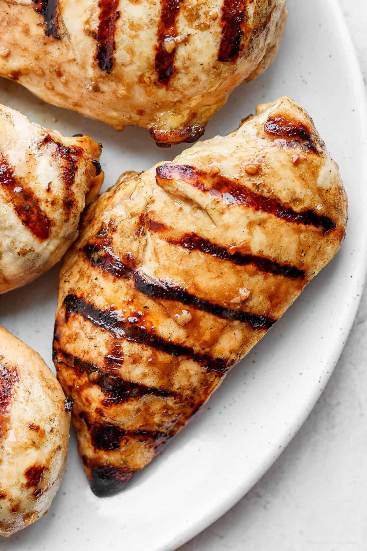 grilled chicken breast on plate.