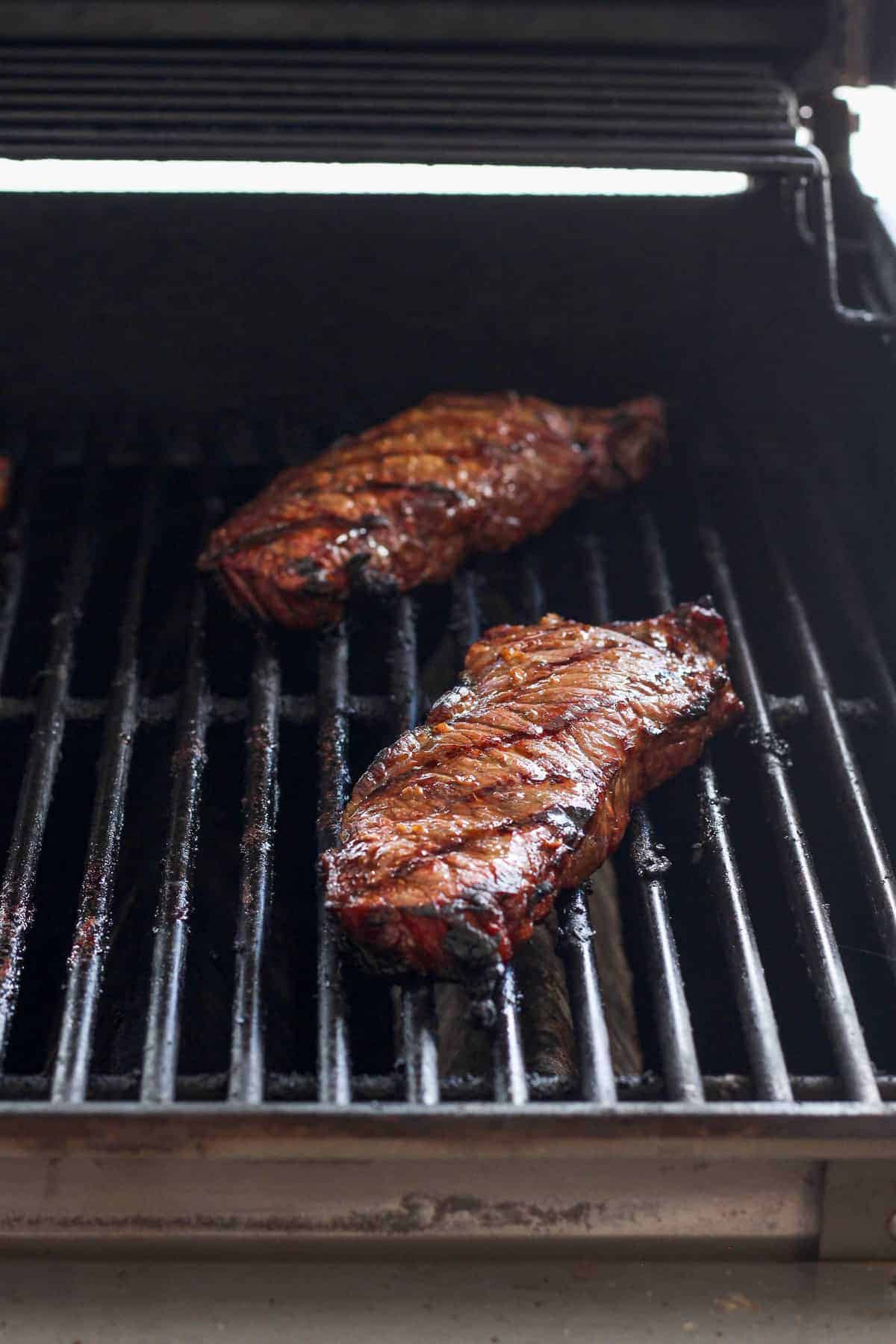 grilling steaks on gas grill.