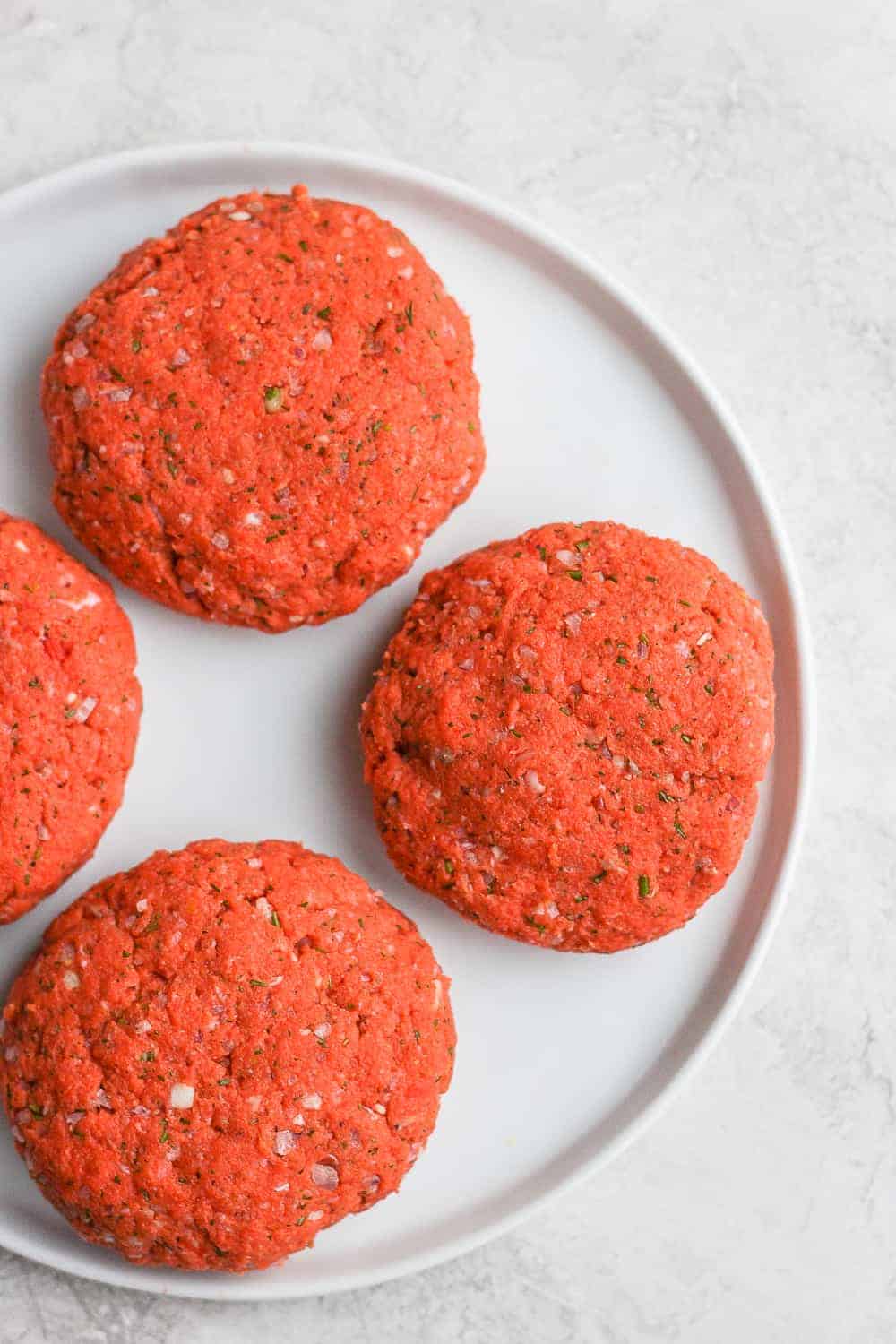 raw salmon patties on plate