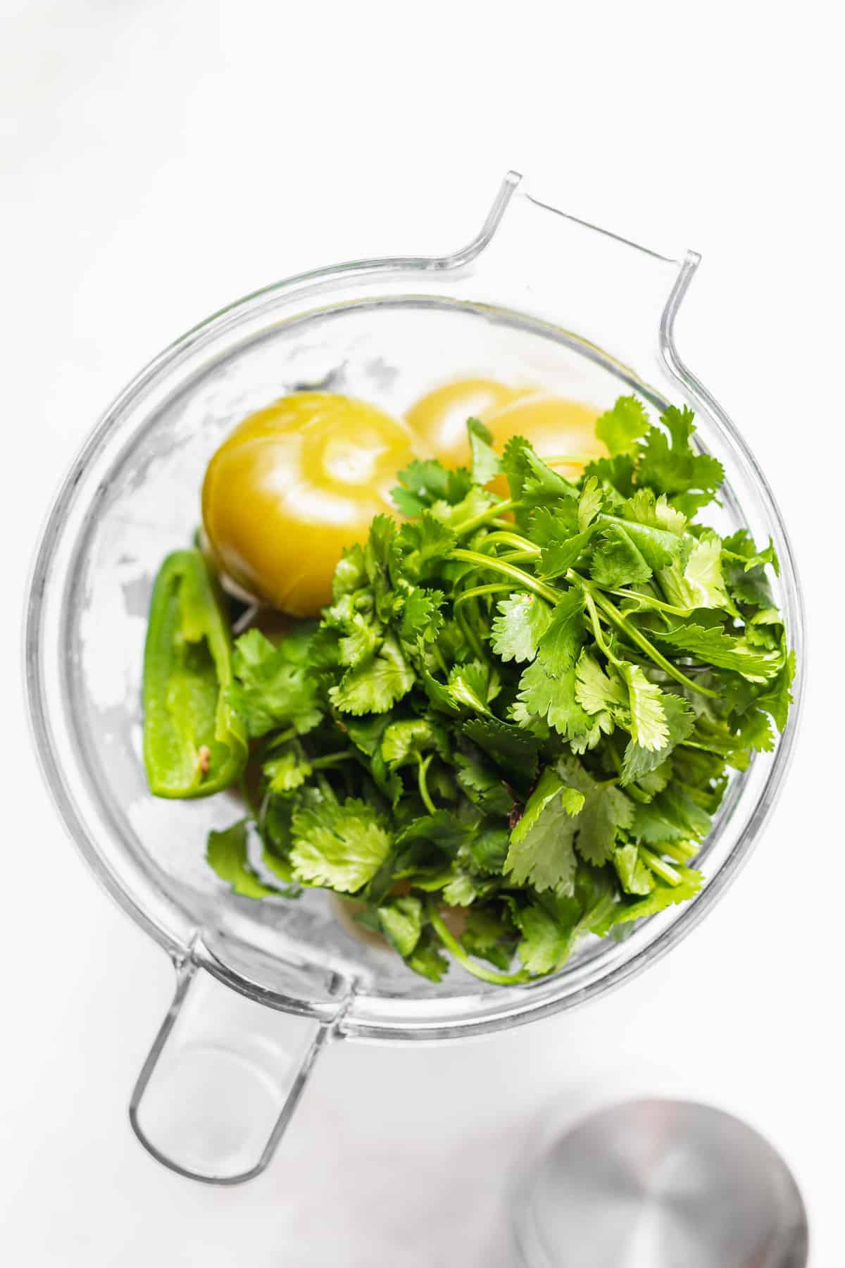 All the ingredients for this salsa verde recipe in a blender. 