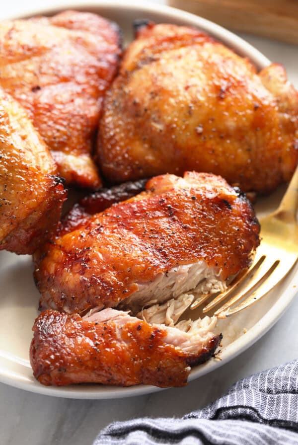 roasted chicken on a plate with a fork.