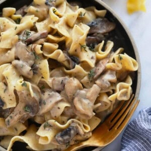 mushroom risotto in a bowl with a fork.