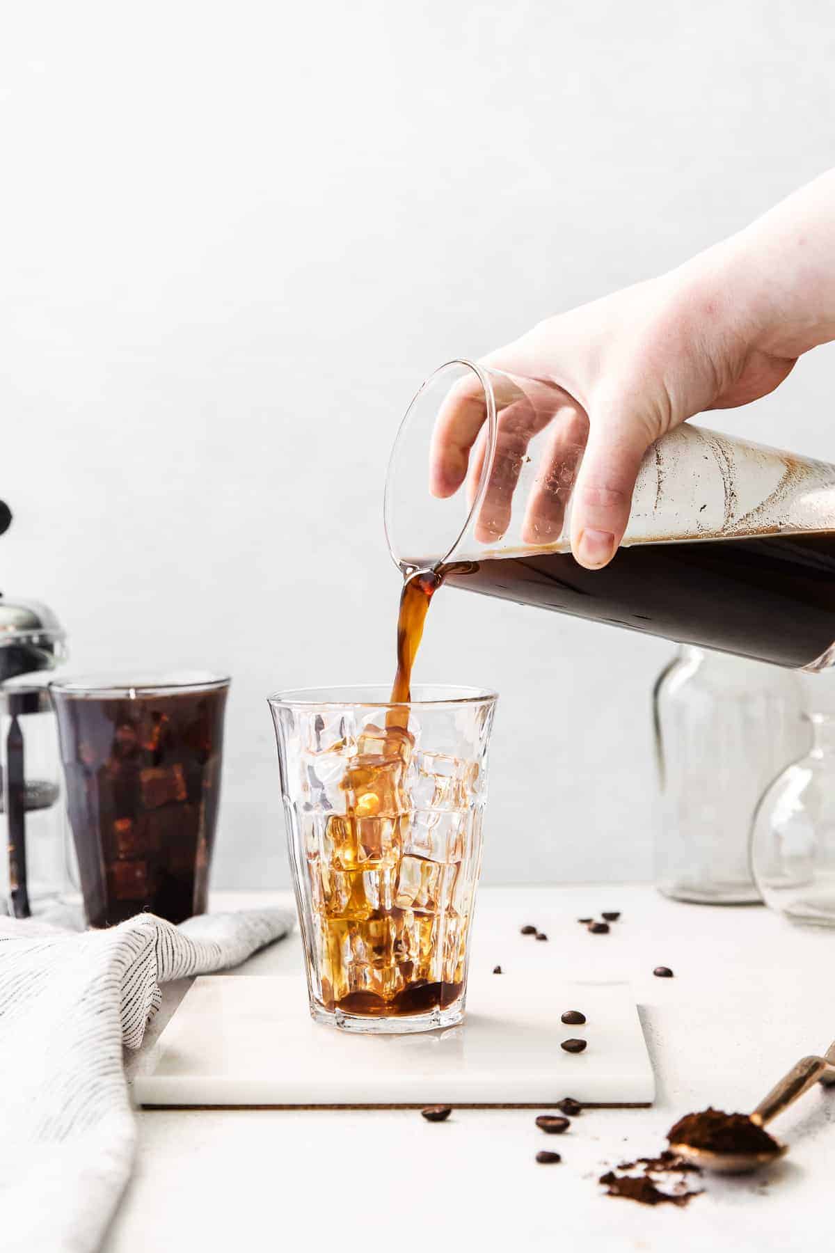 Pouring cold brew coffee into a glass