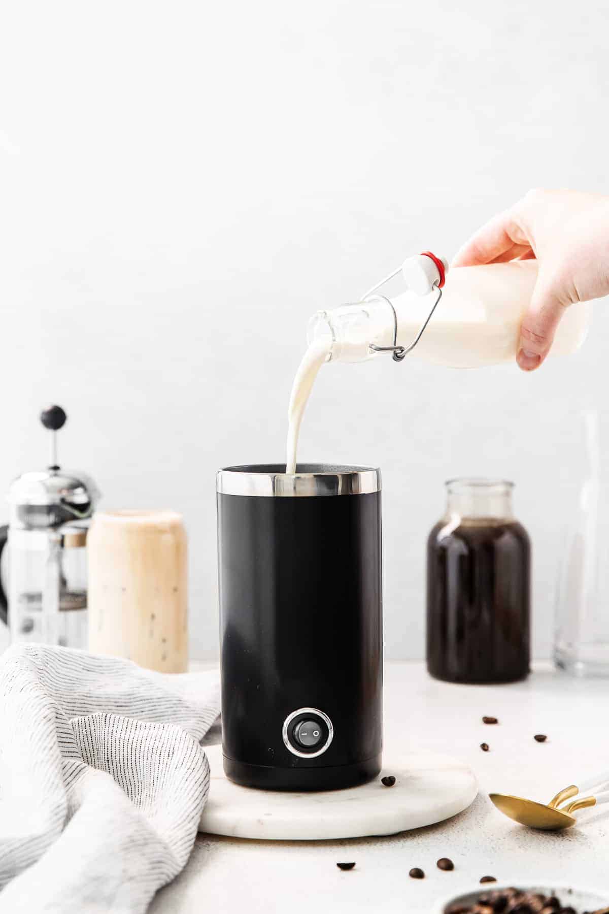 pouring vanilla sweet cream into frother.