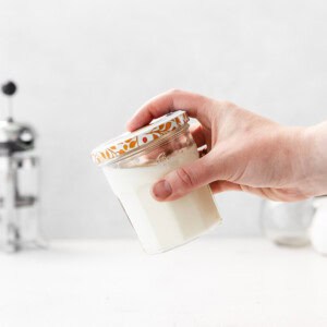 shaking cold foam in jar.