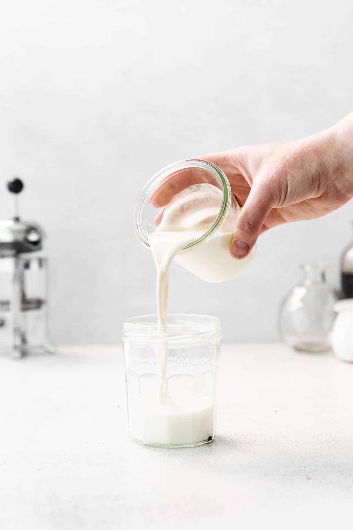 pouring vanilla sweet cream into jar.