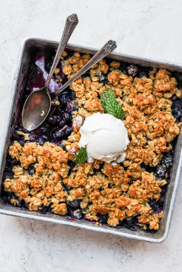 Blueberry crisp with ice cream on top.