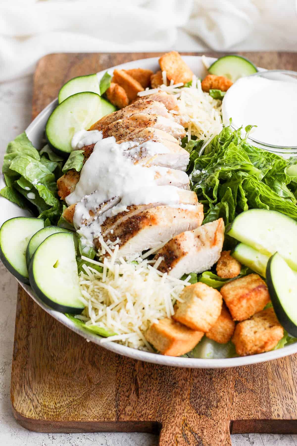 Chicken on top of a salad. 