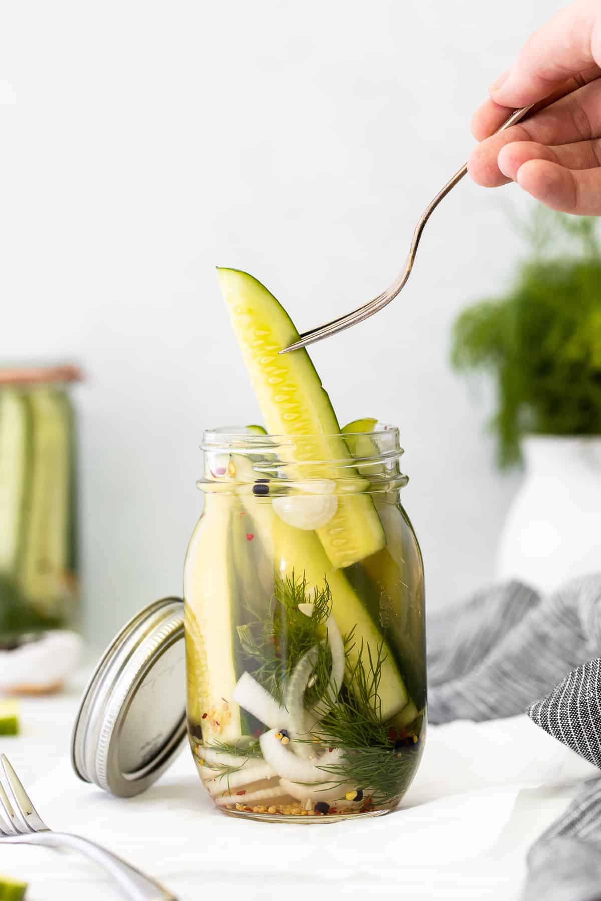 A refrigerator pickle on a fork. 