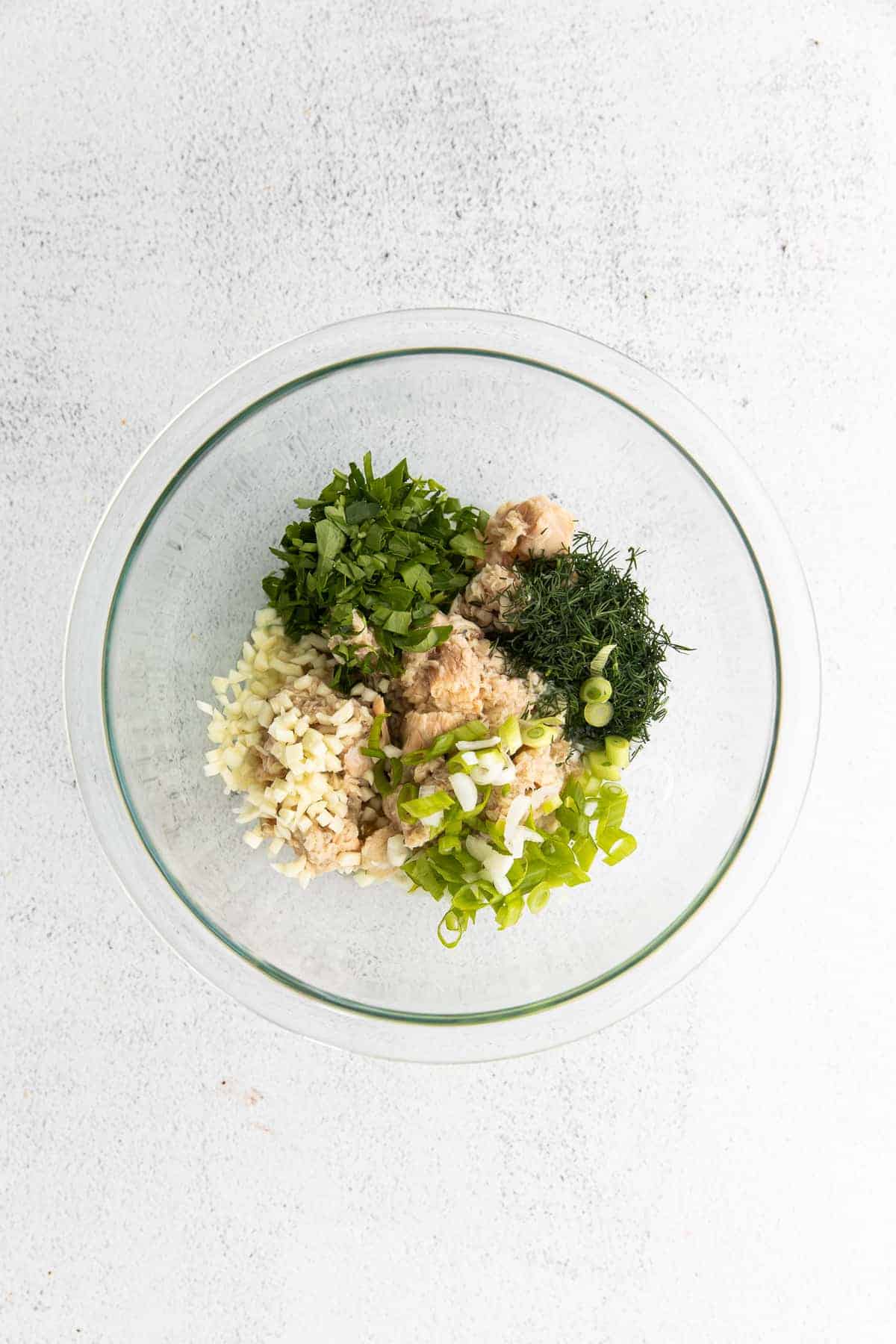 All the ingredients for the salmon salad in a bowl. 