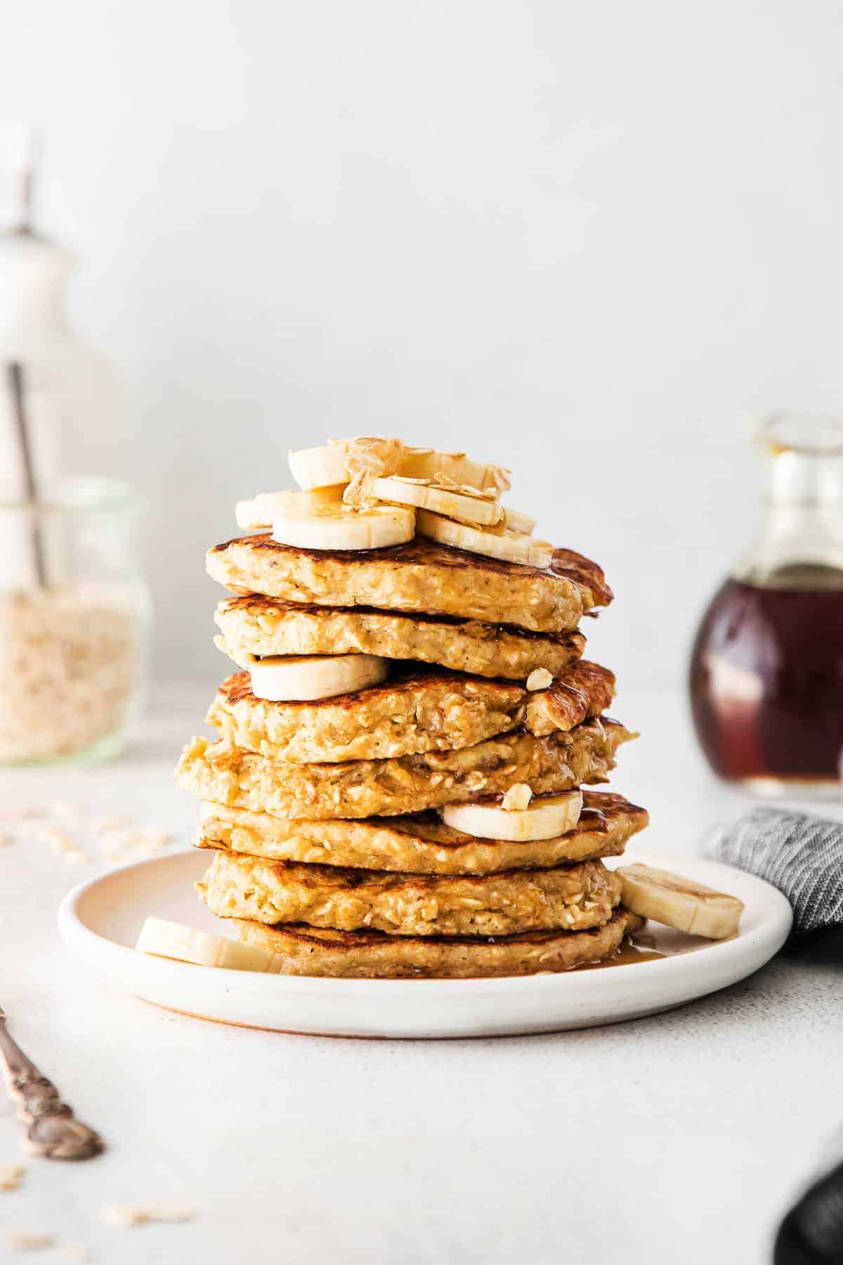 stack of pancakes with banana and oatmeal on top