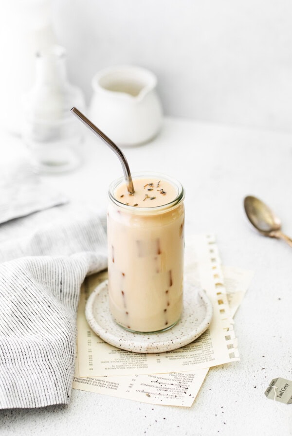 a glass of milk with a straw.